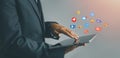 Businessman using tablet with Emoji Social media concept
