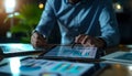 Businessman using tablet and laptop analyzing sales data and economic growth graph chart. Business strategy Royalty Free Stock Photo