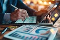 Businessman using tablet and laptop to analyze sales data and stock market chart. Business strategy Royalty Free Stock Photo