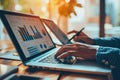 Businessman using tablet and laptop to analyze sales data and stock market chart. Business strategy Royalty Free Stock Photo