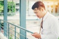 Businessman using tablet mobile phone in outdoor office