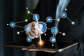Businessman using tablet to access digital interface with various icons representing technology, data, and connectivity Royalty Free Stock Photo