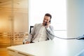 Businessman using talking on phone in office Royalty Free Stock Photo