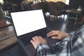 Businessman using and typing on laptop with blank white desktop screen while sitting on a chair Royalty Free Stock Photo