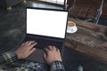 Businessman using and typing on laptop with blank white desktop screen while sitting on a chair Royalty Free Stock Photo