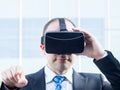 Businessman using virtual reality glasses in a business center Royalty Free Stock Photo