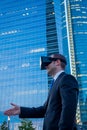 Businessman using virtual reality glasses for a meeting in cyberspace.