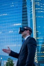 Businessman using virtual reality glasses for a meeting in cyberspace. Royalty Free Stock Photo