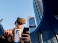 Businessman using virtual reality glasses with a mobile phone in Royalty Free Stock Photo