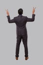 Businessman Very Happy and Excited, Raising arms, Celebrating a Victory or Success View from Back. Winner Sign, Peace Sign. Indian Royalty Free Stock Photo