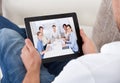 Businessman on a video call chatting to colleagues