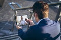 Businessman video calling african american male colleague through digital tablet outside office