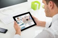 Businessman Videoconferencing With Colleagues On Digital Tablet