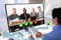 Businessman videoconferencing with his colleagues