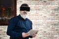 Businessman with vr goggles holding virtual meeting in office using metaverse blockchain technology app