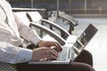 Businessman in airport waiting lounge typing on laptop Royalty Free Stock Photo