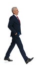 Businessman walking along and putting his hands in his pockets Royalty Free Stock Photo