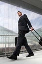 Businessman walking with bag and trolley travel Royalty Free Stock Photo