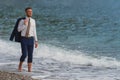 Businessman walking on the beach Royalty Free Stock Photo