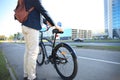 Businessman walking with bike in street after work. Royalty Free Stock Photo