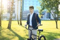 Businessman walking with bike in street after work. Royalty Free Stock Photo