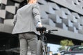 Businessman walking with bike in street after work. Royalty Free Stock Photo