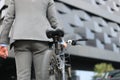 Businessman walking with bike in street after work. Royalty Free Stock Photo