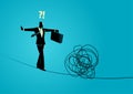 Businessman walking cautiously on a rope and facing a tangled rope in front of him