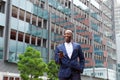 Businessman walking with cell phone in the city Royalty Free Stock Photo