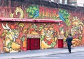 Businessman walking in front of a Graffiti Wall in Brooklyn.