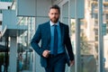 Businessman walking. Businessman in front of office. Handsome businessman. Business portrait of serious business man Royalty Free Stock Photo