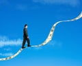 Businessman walking on growing money trend with blue sky background Royalty Free Stock Photo