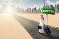 Businessman walking on highway with success text