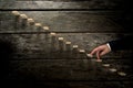 Businessman walking his fingers up wooden steps towards light Royalty Free Stock Photo