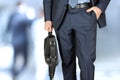 Businessman walking and holding a leather briefcase in his han Royalty Free Stock Photo