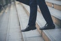 Businessman walking with luggage in business trip. Focus on man legs boarding travel arrival terminal. Business travel trip Royalty Free Stock Photo