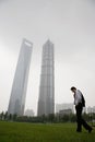 Businessman walking near skyscrapers Royalty Free Stock Photo