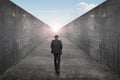 Businessman walking one way road toward exit sun sky view