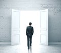 Businessman walking in open door Royalty Free Stock Photo