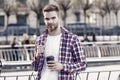 businessman walking outdoor. smart casual dressed person drinking coffee mug outdoor. Caucasian male resting in street Royalty Free Stock Photo