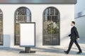 Businessman walking past business center exterior with empty mock up frame stand, windows and shadows in daylight