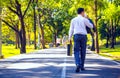 Businessman walking on road in park. Royalty Free Stock Photo