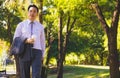 Businessman walking on road in park. Royalty Free Stock Photo