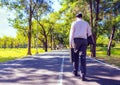 Businessman walking on road in park. Royalty Free Stock Photo