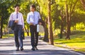 Businessman,They are walking on road in park.They are talking  business. Royalty Free Stock Photo