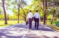 Businessman,They are walking on road in park.They are talking  business. Royalty Free Stock Photo