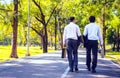 Businessman,They are walking on road in park.They are talking  business. Royalty Free Stock Photo