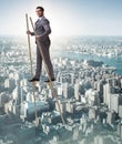 Businessman walking on stilts - standing out from the crowd Royalty Free Stock Photo