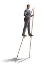 The businessman walking on stilts - standing out from the crowd Royalty Free Stock Photo