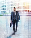 Determinated businessman walking in the city. double exposure Royalty Free Stock Photo